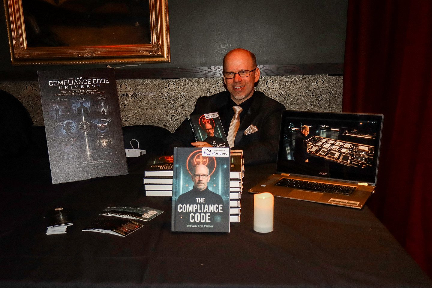An author signing copies of The Compliance Code at the soirée
