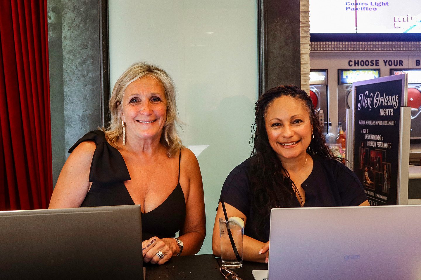 Two members of the Kolenko & Associates team welcoming guests at the registration desk