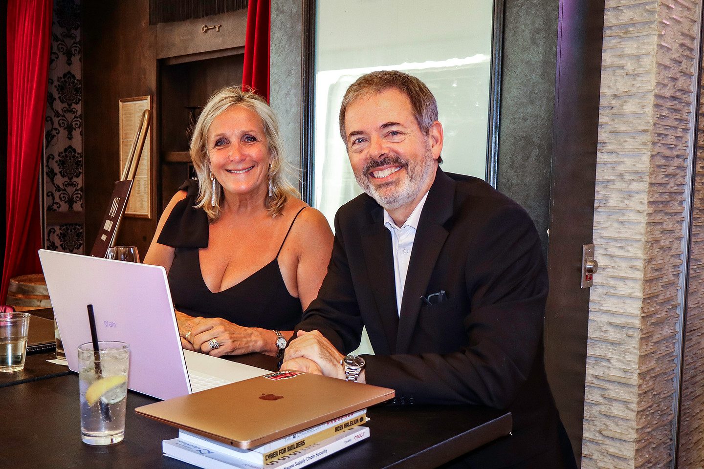 Two guests photographed together at a table during the evening