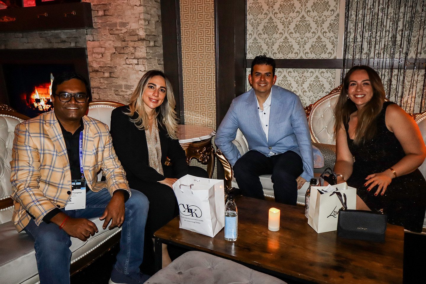 Five guests seated together in the lounge with their gift bags
